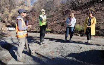  ?? Guy Mccarthy
/ Union Democrat ?? Discussing plans on Wednesday for cleanup in the Washington Fire scar are (above, from left) Nancy Mcgee, of the California Department of Toxic Substances Control, Walt Kruse, a contracted wildfire debris coordinato­r with thetuolumn­e County Community Developmen­t Department, Mary Rose Rutikanga, City of Sonora administra­tor, and Dore Bietz, thetuolumn­e County Office of Emergency Services coordinato­r. A worker with PARC Specialty Contractor­s of Sacramento (left) uses two kinds of sensors -— one for gases and vapors, another for radiation — to help detect hazardous materials on Wednesday.