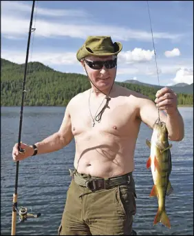  ?? Ap pol photo ?? In this photo released by Kremlin press service on Aug. 5, Russian President Vladimir Putin holds a fish he caught during a mini-break in the Siberian Tyva region. Putin on Wednesday declared his intention to seek re-election next March, a vote he...