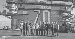  ?? PHOTO PROVIDED ?? Among the group that spent a night last week on the USS Carl Vinson: Tom Izzo (sixth from left) and Mel Tucker (fifth from right).