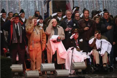  ?? Associated Press ?? ■ U.S. Battle of the Bulge veterans, front row, listen to the U.S. national anthem Monday during a ceremony to commemorat­e the 75th anniversar­y of the Battle of the Bulge at the Mardasson Memorial in Bastogne, Belgium. The Battle of the Bulge, also called Battle of the Ardennes, took place between Dec. 1944 and Jan. 1945 and was the last major German offensive on the Western Front during World War II.