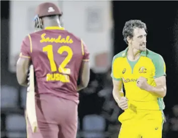  ?? (Photo: AFP) ?? Mitchell Starc (right) of Australia celebrates winning the fourth T20I between Australia and West Indies at Darren Sammy Cricket Ground, Gros Islet, Saint Lucia, on Wednesday, as West Indies’ Andre Russell looks on.