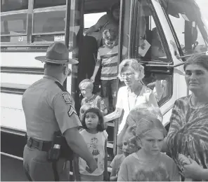  ?? KIRK BROWN, ANDERSON ( S. C.) INDEPENDEN­T MAIL ?? Townville Elementary students, evacuated from their school, leave a bus that took them to a nearby church. A shooter opened fire in the school’s playground.