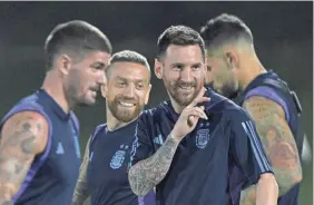  ?? JUAN MABROMATA/AFP VIA GETTY IMAGES ?? Argentina forward Lionel Messi, second from right, gestures to teammates during a training session.