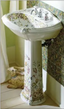  ?? KOHLER VIA AP ?? This photo provided by Kohler shows one of their Prairie Flowers and English Trellis pedestal sinks, which bring the garden indoors, to a powder room or small bath.