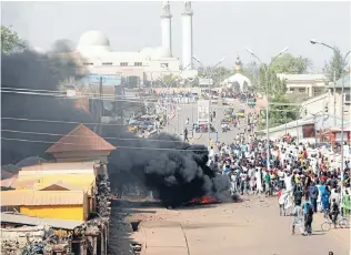  ?? Photo: REUTERS ?? Surge in violence: Smoke is seen after an suicide bomb explosion in Gombe, a day ahead of a visit by Nigerian President Goodluck Jonathan to the state for an election campaign rally.