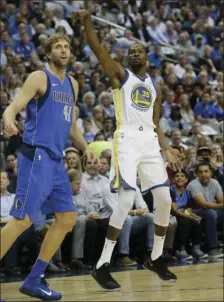 ?? AP PHOTO/LM OTERO ?? Golden State Warriors forward Kevin Durant (right) watches his shot fall good against Dallas Mavericks forward Dirk Nowitzki (left) of Germany during the first half of an NBA basketball game in Dallas on Monday.