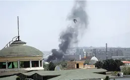  ?? — AP ?? Smoke rises next to the US embassy in Kabul on Sunday. Taliban fighters entered the outskirts of the Afghan capital, further tightening their grip on the country.