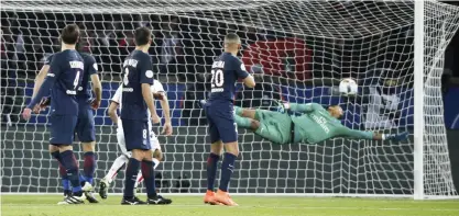  ??  ?? PARIS: PSG goalkeeper Alphonse Areola, right, jumps to stop a goal during a League One soccer match against Nice, at the Parc des Princes stadium, in Paris, France, Sunday.— AP