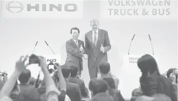  ?? ASSOCIATED PRESS ?? Andreas Renschler, right, a board member at Volkswagen AG and CEO of Volkswagen Truck & Bus, and Hino Motors President and Chief Executive Yoshio Shimo, left, pose for the media during a press conference in Tokyo, Thursday, April 12, 2018. Hino Motors,...