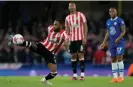  ?? Kirsty Wiggleswor­th/AP ?? Rico Henry in action during Brentford’s win at Chelsea on Wednesday. Photograph: