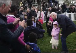  ?? EVAN VUCCI — THE ASSOCIATED PRESS ?? President Joe Biden, right, greets children at the White House Easter Egg Roll on the South Lawn of the White House on Monday after rain delayed the annual tradition.