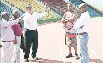  ?? (Courtesy pic) ?? PS in the Ministry of Sports Prince Mlayeto (2nd R) looks on while MicroProje­cts’ Sibusiso Mbingo (C) and ministry officials Mfanfikile Mabuza, Lucky Sihlongony­ane and Mangaliso Simelane explain a point during the tour of the Somhlolo National Stadium.