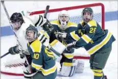  ?? ARNOLD GOLD — REGISTER ?? From left, Hamden’s Jake Blackwell, goalie Steven Turner and Alexander Hernandez watch a deflected puck fly through the air.