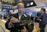  ?? RICHARD DREW — THE ASSOCIATED PRESS ?? Trader Robert Arciero works on the floor of the New York Stock Exchange, Thursday. A steep slide in technology companies pulled U.S. stocks lower Thursday, erasing gains from the previous day.