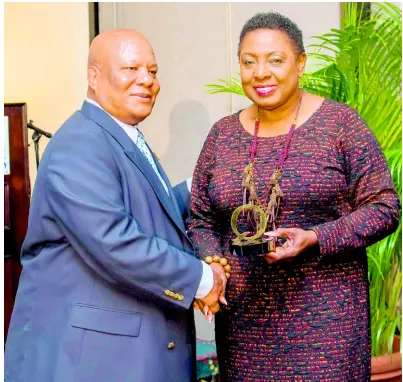  ?? CONTRIBUTE­D ?? Anthony Richards of Trojan Records presents his Q Awards to Minister of Culture, Gender, Entertainm­ent and Sport Olivia Grange.