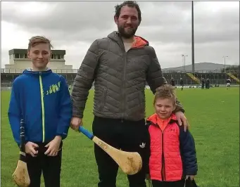  ??  ?? In a joyous mood at the Kerry v Cork hurling game at Austin Stack Park on Sunday were Ballyduff great Mikey Boyle with his sons Killian and Bobby.Photo Moss Joe Browne.