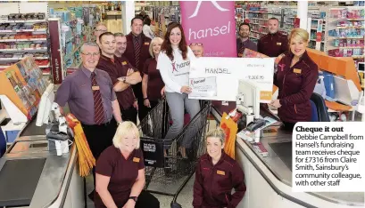  ??  ?? Cheque it out Debbie Campbell from Hansel’s fundraisin­g team receives cheque for £ 7316 from Claire Smith, Sainsbury’s community colleague, with other staff