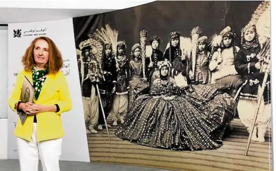  ?? —LITO B. ZULUETA ?? Christine Barthe, curator of Louvre Abu Dhabi’s first internatio­nal photo exhibit, before a blown-up photo by Johnston and Hoffmann of the Maharani of Nepal and her ladies-in-waiting (1885-1894); from Musée du quai Branly–Jacques Chirac.