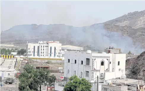  ?? REUTERS ?? Smoke rises during clashes in Yemen last week. A Saudi-led coalition yesterday launched strikes against rebels after they seized the presidenti­al palace in Aden.