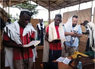  ??  ?? PRAYING WITH members of Kahal Kadosh She’erit Yisrael.