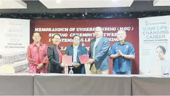  ?? ?? Christine (second left) and Tiong exchange the signed MoU documents, witnessed by Dr Jerip (centre). Looking on are Tan (left) and Ahmad.