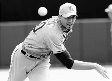  ?? JOHN BAZEMORE/AP ?? Tampa Bay Rays starting pitcher Charlie Morton (50) warms up between innings during a spring training game against the Baltimore Orioles on March 2 in Sarasota. The Rays and MLB are figuring out how to resume play.