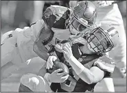  ?? AP/JASON BEHNKEN ?? Tampa Bay defensive back Jordan Whitehead tackles Cleveland quarterbac­k Baker Mayfield in Sunday’s game. Even though Whitehead lowered his head, no penalty was called because Mayfield had not started his slide, said referee Shawn Hochuli.