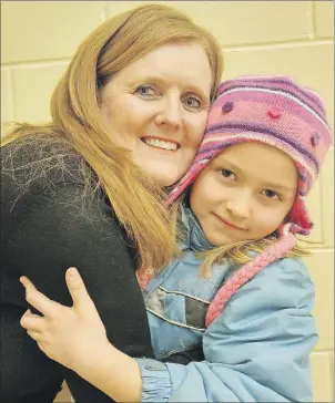  ?? MAUREEN COULTER/TC MEDIA ?? Cathy Cairns received a big hug from Grade 1 student Aislyn Ferguson after it was announced that Cairns received the 2017 Extra Mile Award. Cairns says she always tries to show students that she cares.