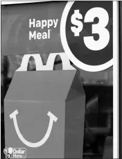  ?? ASSOCIATED PRESS ?? A $3 HAPPY MEAL IS ADVERTISED in Brandon, Miss., Wednesday. at a McDonald’s restaurant