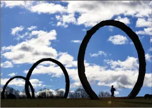  ?? Washington Post photo by Katherine Frey. ?? At the North Carolina Museum of Art’s 164-acre Ann and Jim Goodnight Museum Park, people walk through local artist Thomas Sayre’s “Gyre,” a set of gigantic earthcasti­ng rings. Photograph­ed Jan. 5, 2019, in Raleigh, North Carolina.