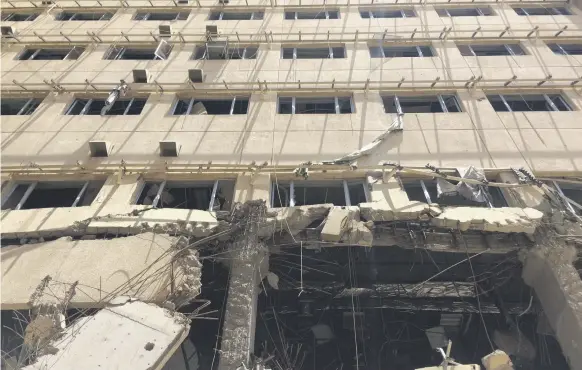  ?? Sofia Barbarani / The National ?? More than two years after the liberation of Ramadi, the hospital is still badly damaged and unswept for explosives; left, a former minor surgery unit; right, a temporary emergency unit next to the hospital site