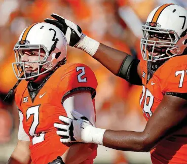  ?? [PHOTO BY BRYAN TERRY, THE OKLAHOMAN] ?? After coming to Oklahoma State as a graduate transfer, Aaron Cochran, right, had a successful senior season as the Cowboys’ left tackle, protecting the blind side of quarterbac­k Mason Rudolph.