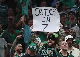  ?? NANCY LANE PHOTOS / HERALD STAFF ?? NEXT ROUND: Celtics fans hold a sign reading “Celtics in 7”during Game 7 of the Eastern Conference semifinals against the Bucks.