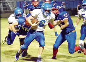  ?? Photo by Mike Eckels ?? Decatur’s Troy Kell (6) fights off several Dragon tacklers during the Sept. 23 Decatur-Mountainbu­rg conference game in Mountainbu­rg. The Dragons won, 50-6.