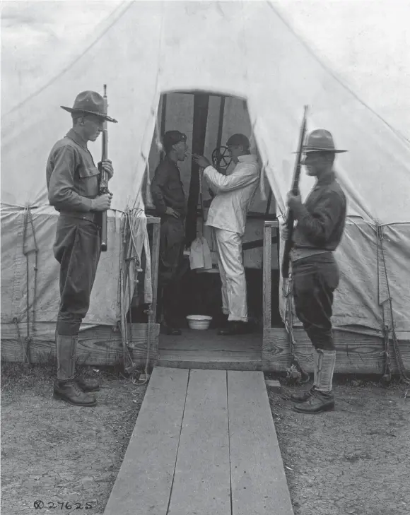  ?? SHUTTERSTO­CK ?? American soldier gets throat sprayed to prevent influenza, Dec. 1918. Medical tent at Love Field, Dallas, Texas, during the 1918-19 influenza pandemic.