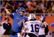  ?? AP PHOTO BY STEVE CONNER ?? Boise State quarterbac­k Brett Rypien (4) looks to throw down field as BYU linebacker Sione Takitaki (16) puts pressure on in the second half of an NCAA college football game, Saturday, Nov. 3, in Boise, Idaho. Boise State won 21-16 over BYU.