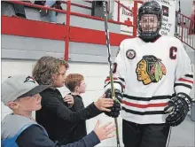  ?? CLIFFORD SKARSTEDT EXAMINER ?? Lakefield Chiefs' captain Braeden Kublick greets young fans during the team’s home opener against the Amherstvie­w Jets on Saturday.