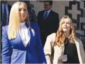  ?? BILLY SCHUERMAN/THE VIRGINIAN-PILOT VIA AP ?? Abby Zwerner, right, a teacher shot by her 6-year-old student, leaves after a hearing Friday for a civil lawsuit she filed against the Newport News Public Schools in Newport News, Va.