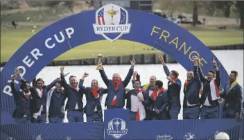  ?? FRANCOIS MORI/AP ?? IN THIS SEPT. 30, 2018, FILE PHOTO, Europe team captain Thomas Bjorn, center, holds the trophy as he celebrates with his team after Europe won the Ryder Cup on the final day of the 42nd Ryder Cup at Le Golf National in Saint-Quentin-en-Yvelines, outside Paris, France.