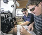  ?? PHOTOS BY ALAN YOUNGBLOOD / STAR-BANNER ?? Instructor David Kissel (right) and Trinity Catholic High School senior Clayton Wilson go over the checklist as they prepare for an afternoon instructio­n flight at Ocala Aviation recently.