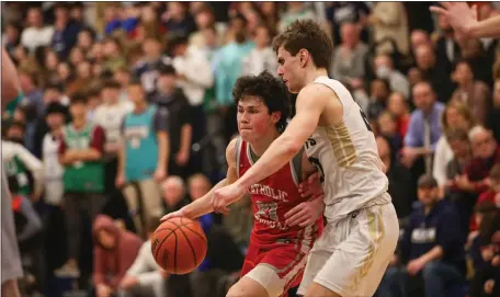  ?? PHOTO BY REBA SALDANHA — BOSTON HERALD ?? Catholic Memorial’s Peter Gellene, left, is defended by Needham’s Jackson Shaw on Thursday in Needham. Catholic Memorial rallied for a 69-63 win.