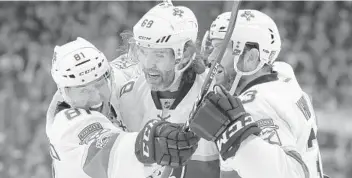  ?? CHRIS O’MEARA/AP ?? Florida Panthers right wing Jaromir Jagr (68) celebrates with center Jonathan Marchessau­lt (81) and defenseman Keith Yandle (3) after scoring against the Tampa Bay Lightning during the first period Saturday.