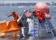  ?? MARK MULLIGAN ?? FILE - In this July 13, 2017, file photo, NASA astronaut Mike Fincke jumps into a life raft from an Orion capsule the astronauts are using for a recovery test about four miles off of Galveston Island, Texas in the Gulf of Mexico, the first time since the Apollo program that NASA has practiced such egress techniques from a capsule in open water.