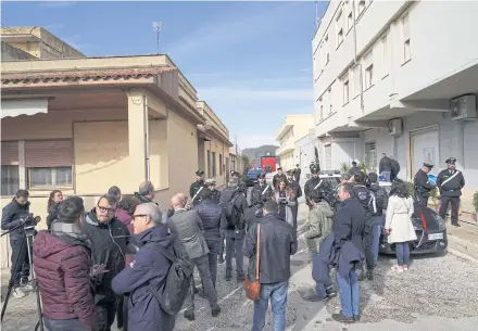  ?? ?? LIFE IN HIDING: The media gathers as Carabinier­i police stand guard near the hideout of Matteo Messina Denaro after he was arrested in the Sicilian town of Campobello di Mazara on Jan 17.