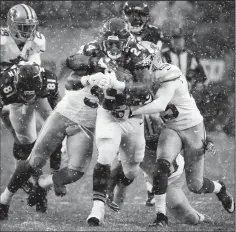  ?? NUCCIO DINUZZO/TRIBUNE NEWS SERVICE ?? Chicago Bears running back Jordan Howard (24) drags a few members of the 49ers defense through the snow on Sunday at Soldier Field in Chicago, Ill.