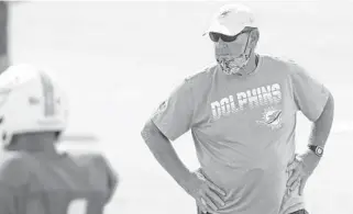  ?? SUSAN STOCKER / SOUTH FLORIDASUN SENTINEL ?? Dolphins offensive coordinato­r Chan Gailey watches practice during training camp at Doctors Hospital Training Facility at Nova Southeaste­rn University in Davie last August.