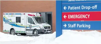  ?? BOB TYMCZYSZYN/ STANDARD STAFF ?? An ambulance parks outside the emergency doors at St. Catharines hospital Tuesday. Last year Niagara paramedics spent 15,438 hours waiting outside emergency department­s.