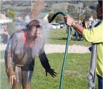  ??  ?? Even the Yarragon Primary School teachers get involved. Pictured is grade five-six teacher Rachel Morgan getting hosed off.