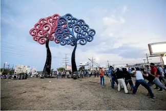  ?? PHOTO: AP ?? Anti-government protesters pull down a statue that is emblematic of the government of Nicaraguan President Daniel Ortega, at the Jean Paul Jennie round-about in Managua.