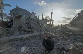  ?? GETTY IMAGES — FOR TRIBUNE NEWS SERVICE ?? A man sits amid the debris of destroyed houses in the aftermath of Israeli bombardmen­t in Rafah in the southern Gaza Strip last week.